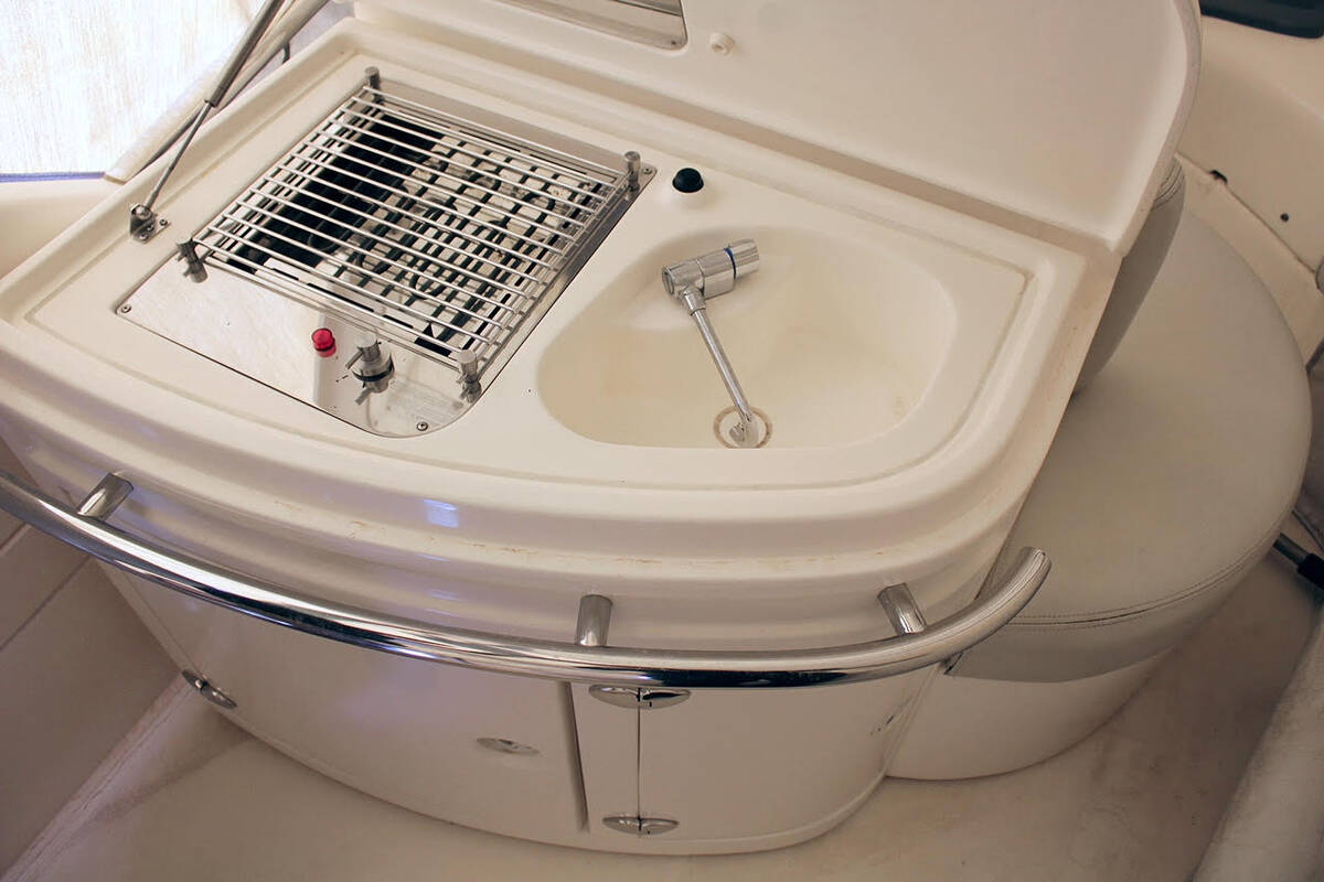 Wet bar with sink and BBQ on flybridge