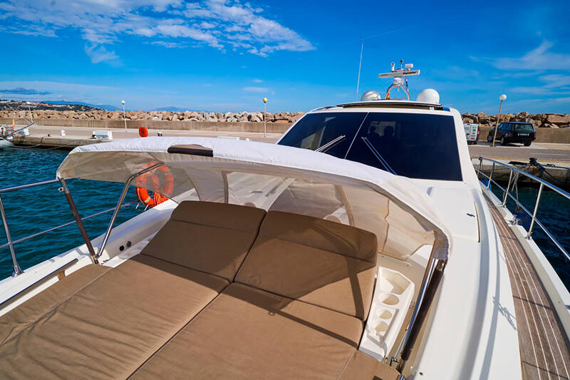 Sunbathing cushions on bow with Bimini top