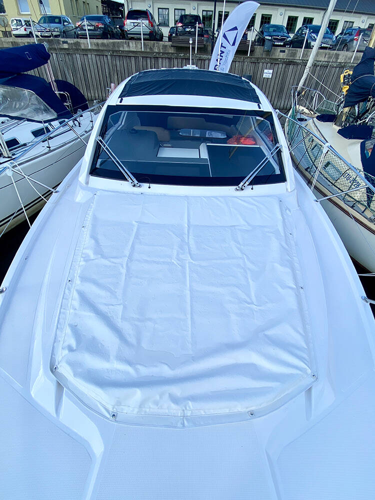 Sunbathing cushions on bow with covers